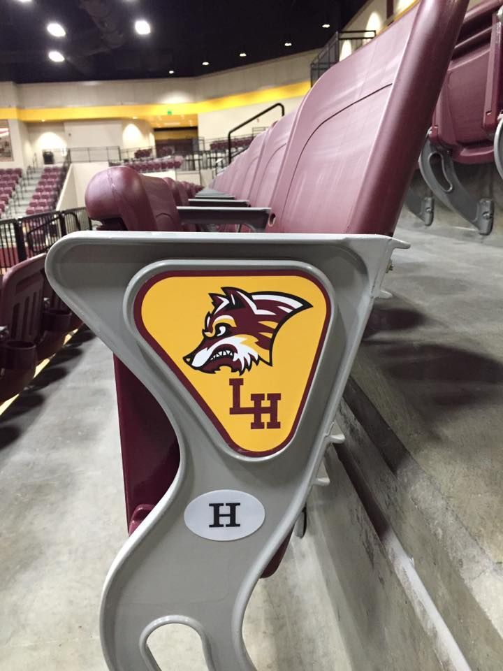 Maroon stadium seat with a Minnesota Duluth Bulldogs logo and LH emblem in an arena.