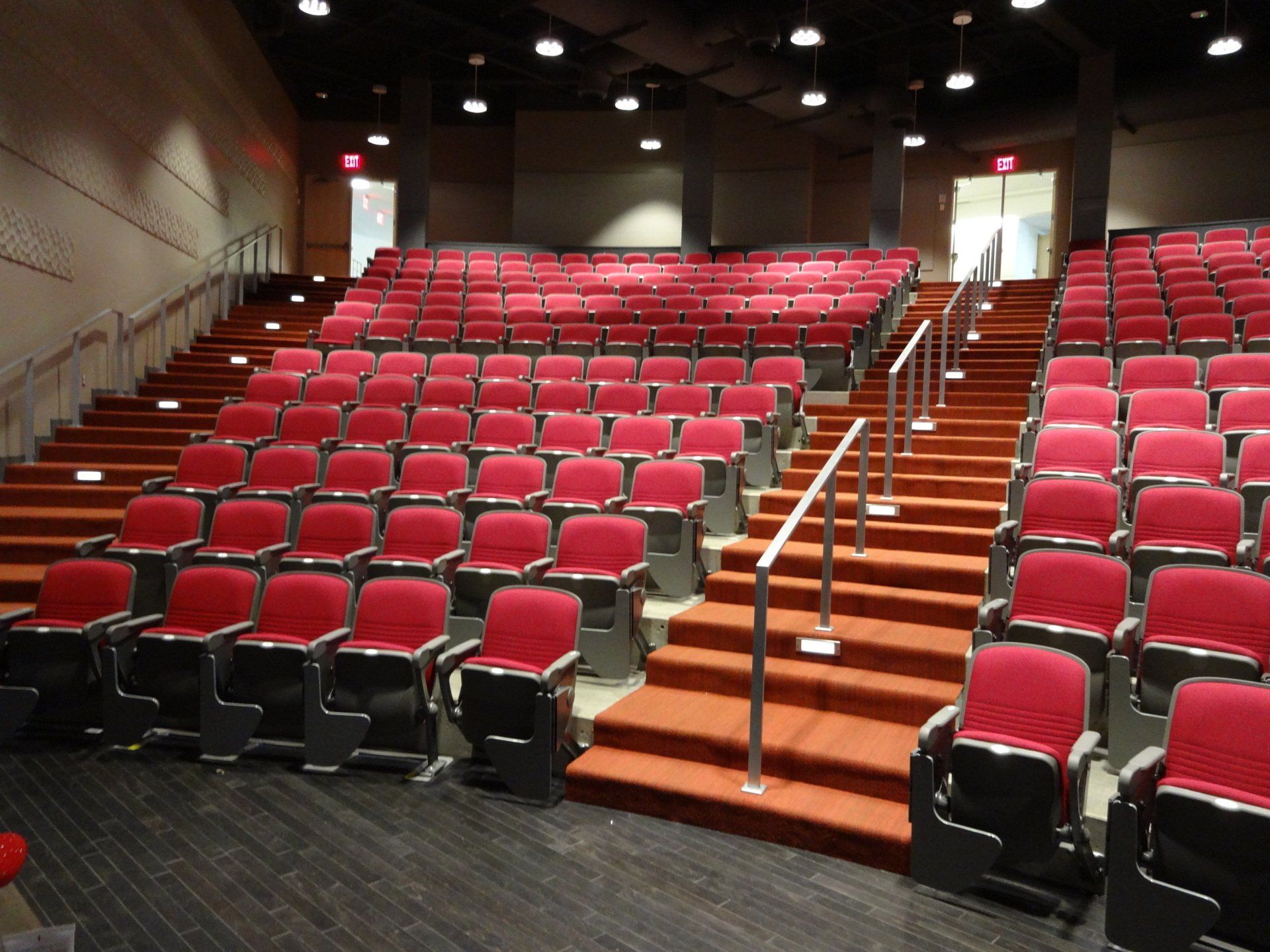 U of A theater auditorium with red seats and central stairs