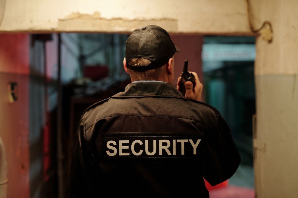 Security Guard with Walkie-Talkie Stands in Doorway — Safe Guard Squad in Byron Bay, NSW