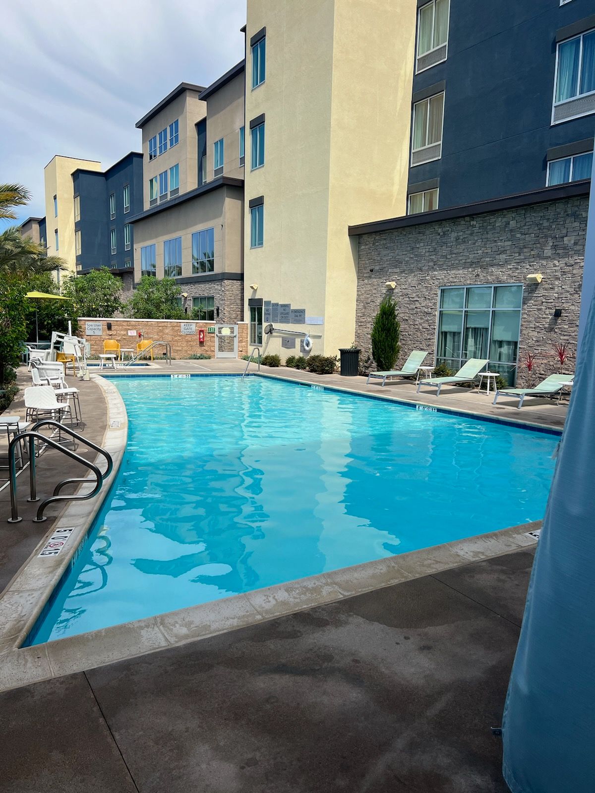 A large swimming pool with a building in the background