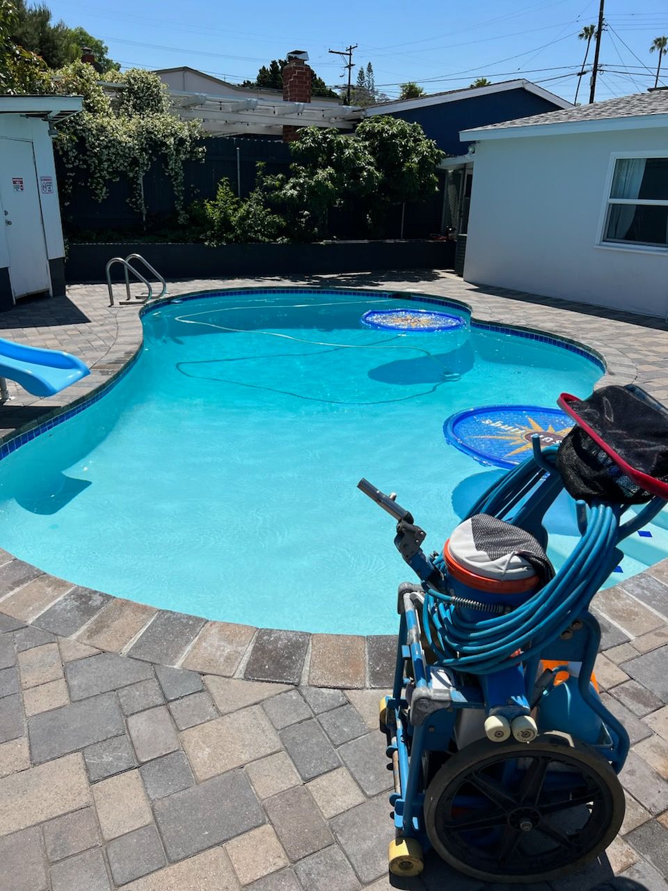 An air compressor is sitting next to a swimming pool