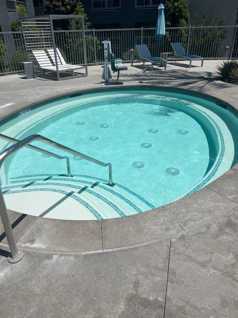 A large swimming pool with stairs leading to it