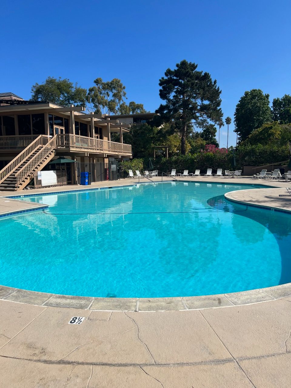 A large swimming pool with a building in the background