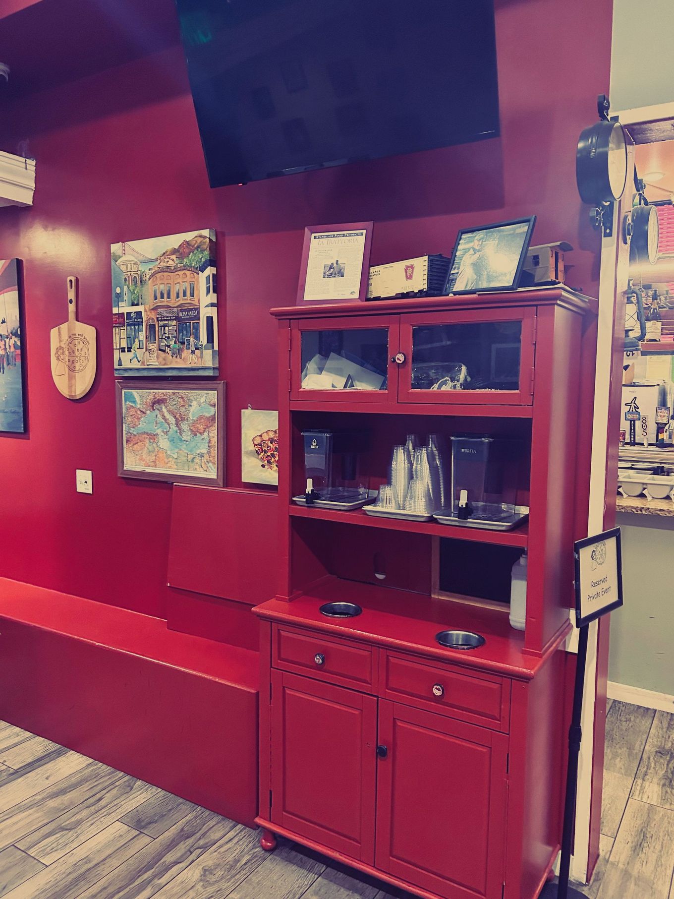 A red cabinet in a room with red walls