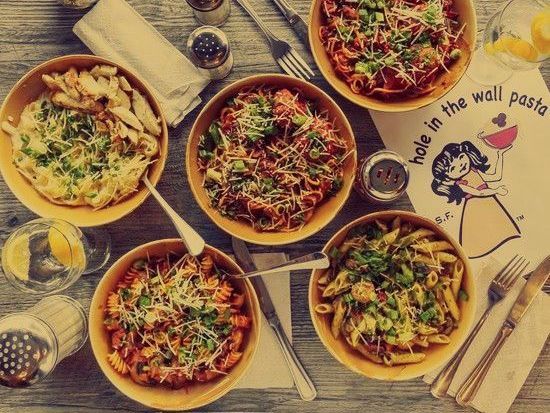 A table topped with bowls of pasta