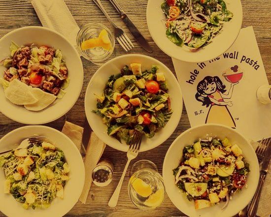 A table topped with bowls of food and a napkin that says 