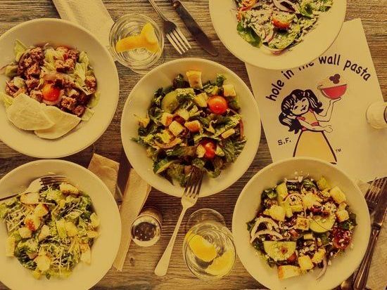 A table topped with bowls of food