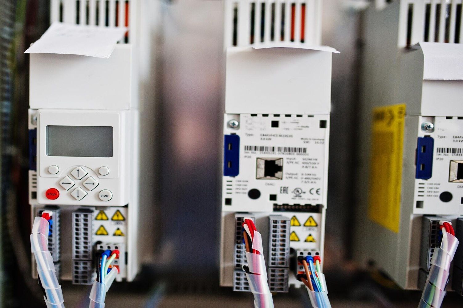 Close-up of electrical control units with digital displays and wiring in a cabinet