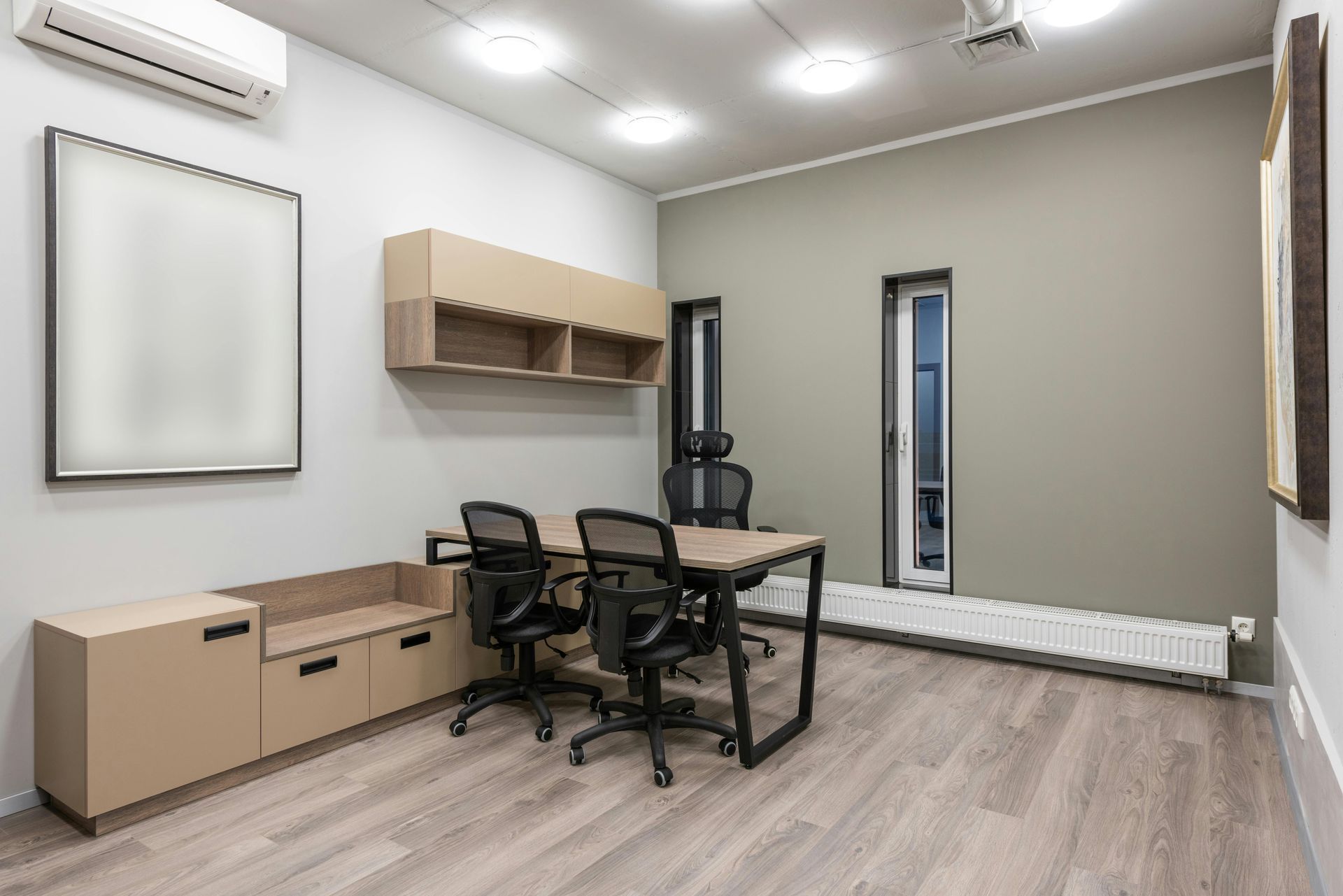 Modern office with desk, chairs, cabinets, and window. Beige and gray tones.