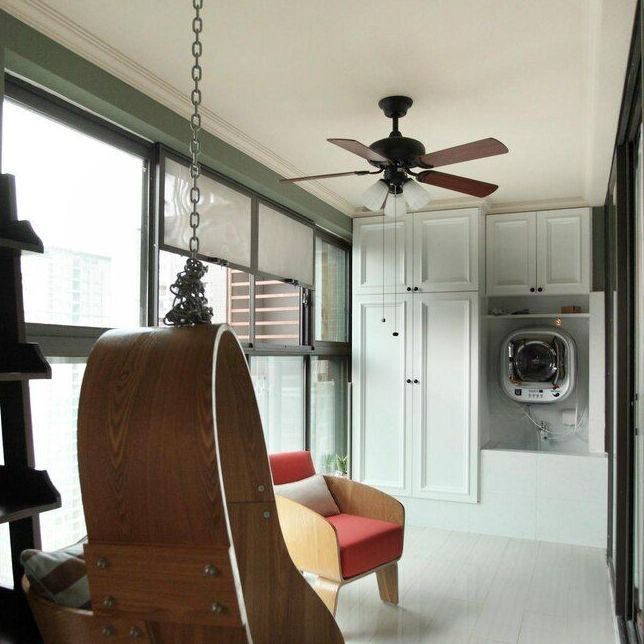 Enclosed porch with hanging chair, red seat, ceiling fan, and wall-mounted dryer cabinets