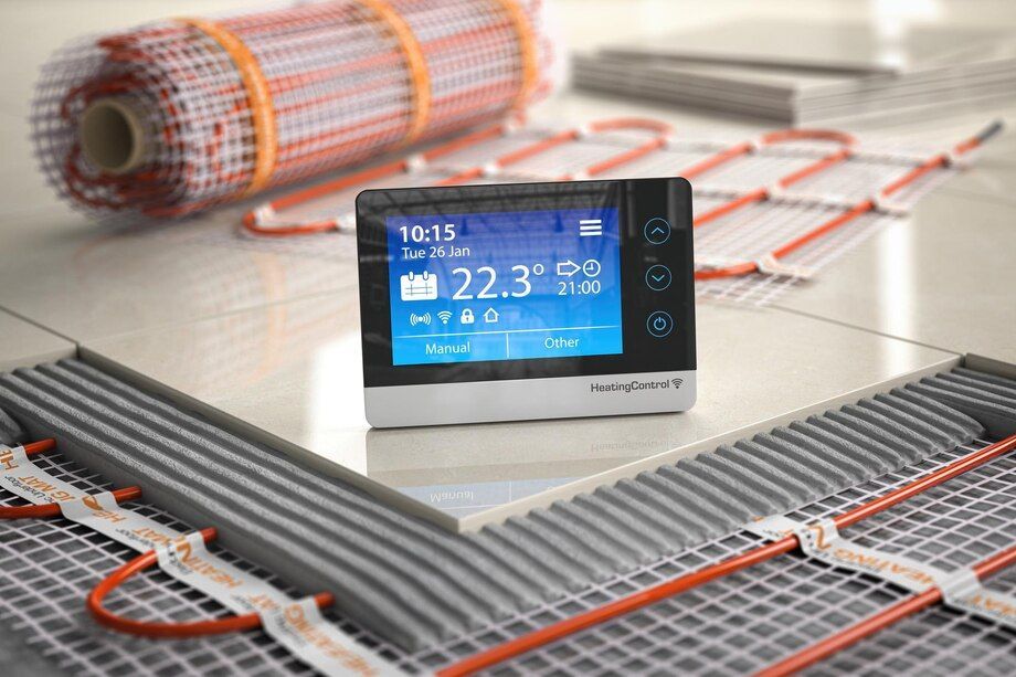 Smart thermostat on floor heating mats, showing 22.3°C with coiled heating cables in the background