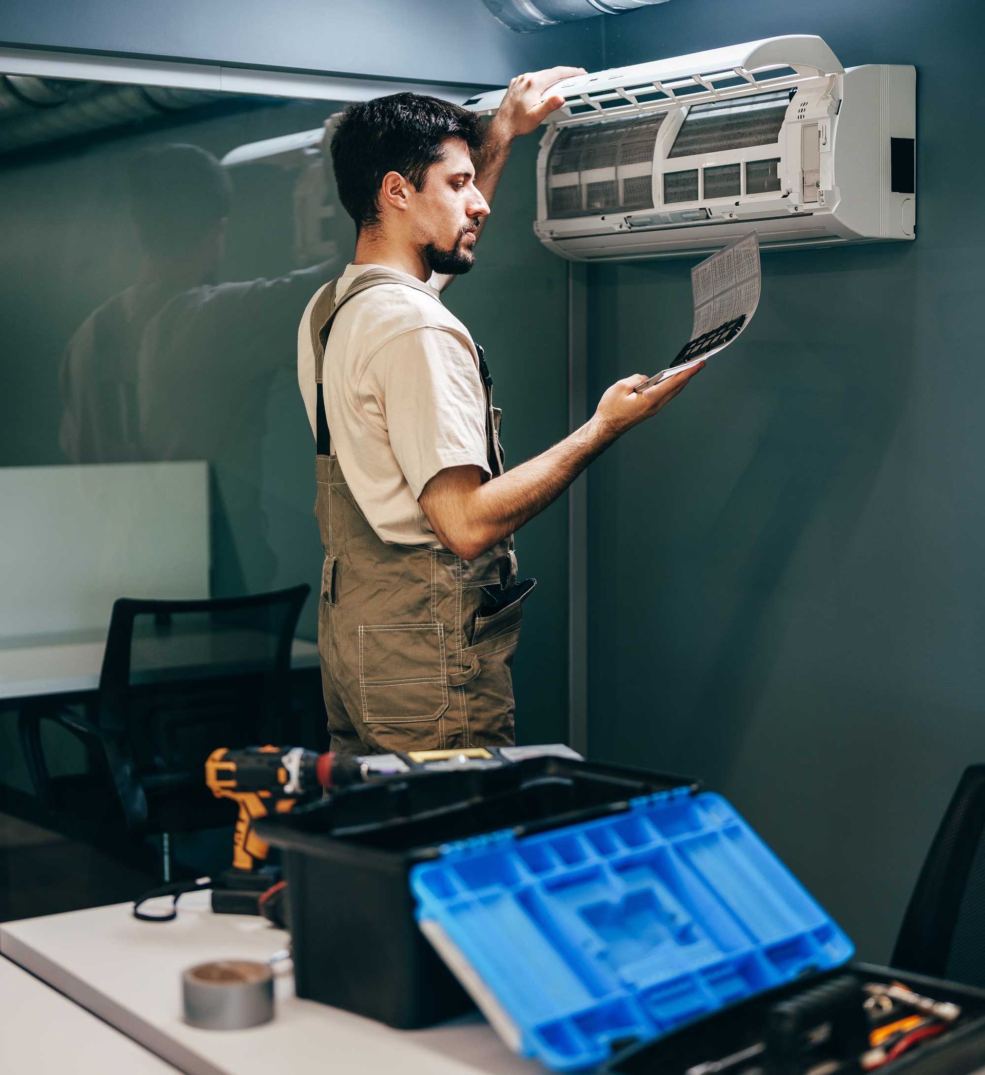 Technician performs maintenance on air conditioning. Technician performs maintenance on air conditioning.