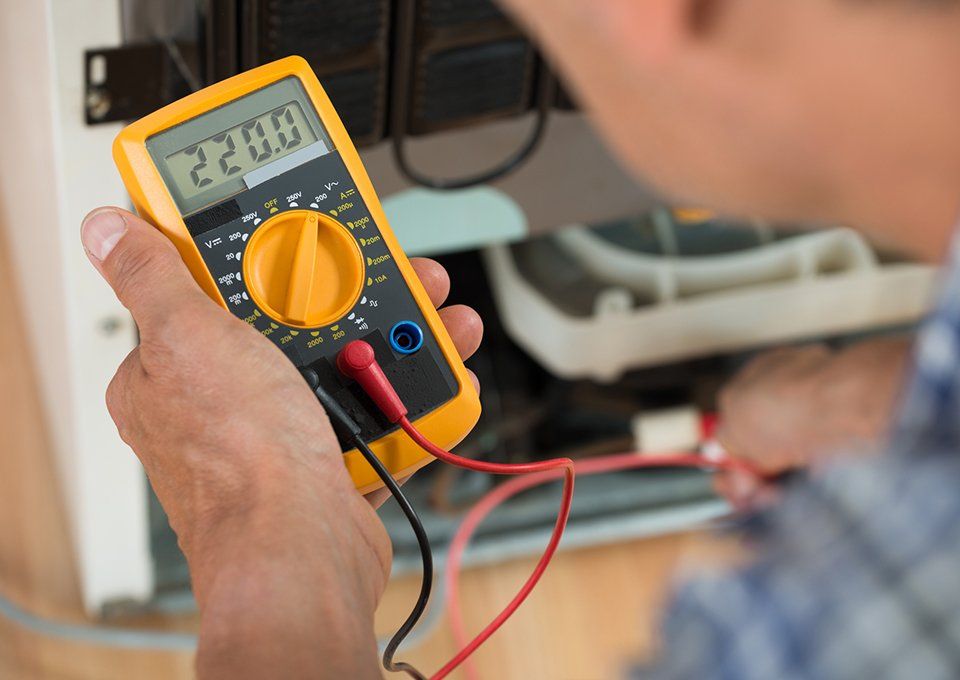 Repairman Checking Fridge — Chicago, IL — HVAC Technical Institute