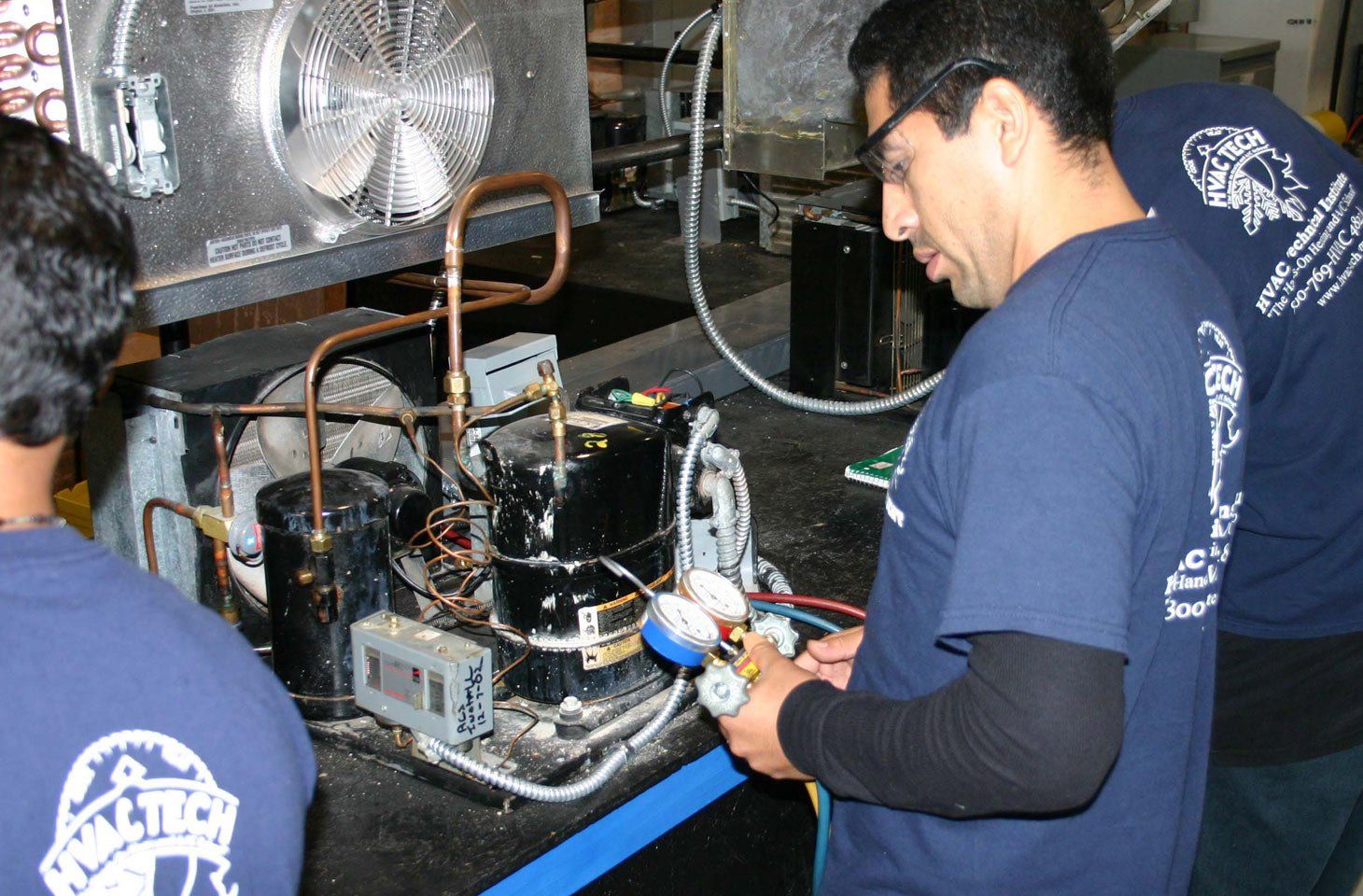 The Technician Is Checking The Air Conditioner — Chicago, IL — HVAC Technical Institute