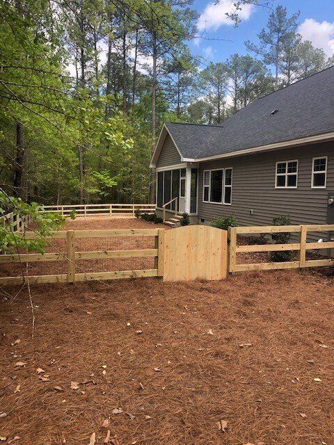 A house with a wooden fence in front of it
