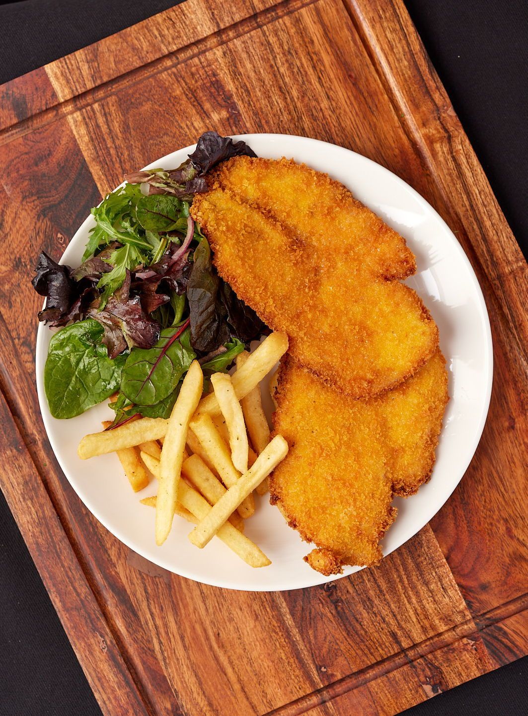 a white plate topped with fried chicken and french fries