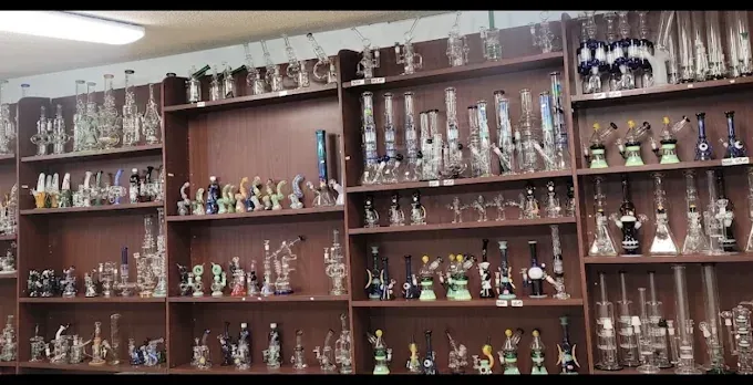 Shelves filled with many glass trophies and decorative awards in a display case