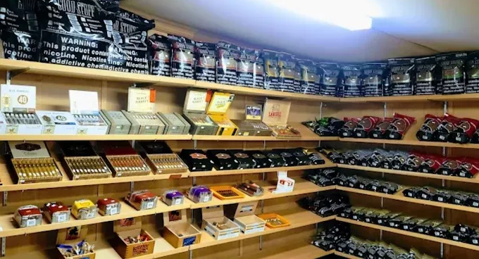 Shelves stocked with assorted tea tins in a brightly lit shop aisle