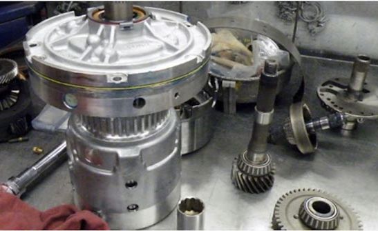 A close up of a machine with gears on a table.