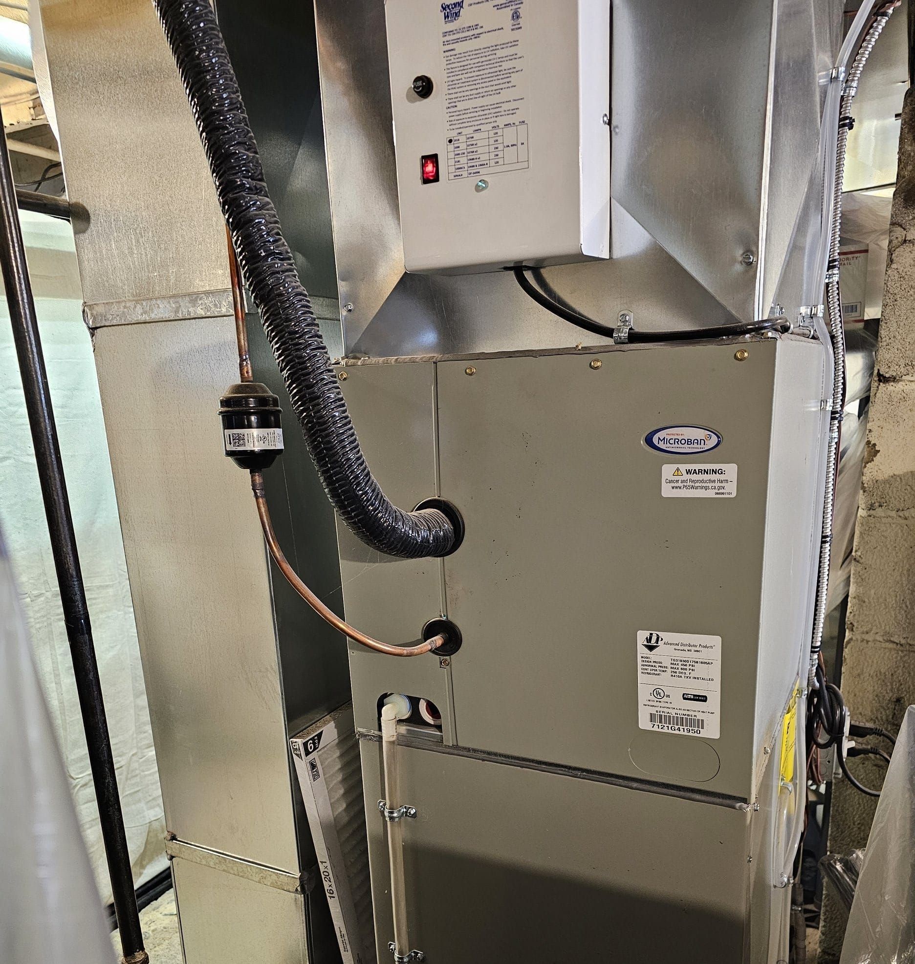 An air conditioner with a hose attached to it
