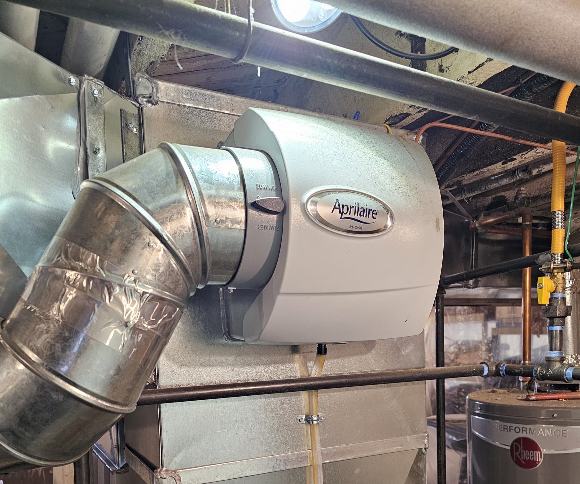 A large metal pipe is hanging from the ceiling of a building.
