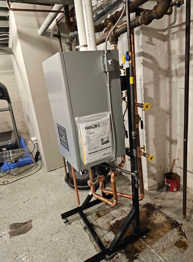 A water heater is sitting on top of a metal stand in a basement.