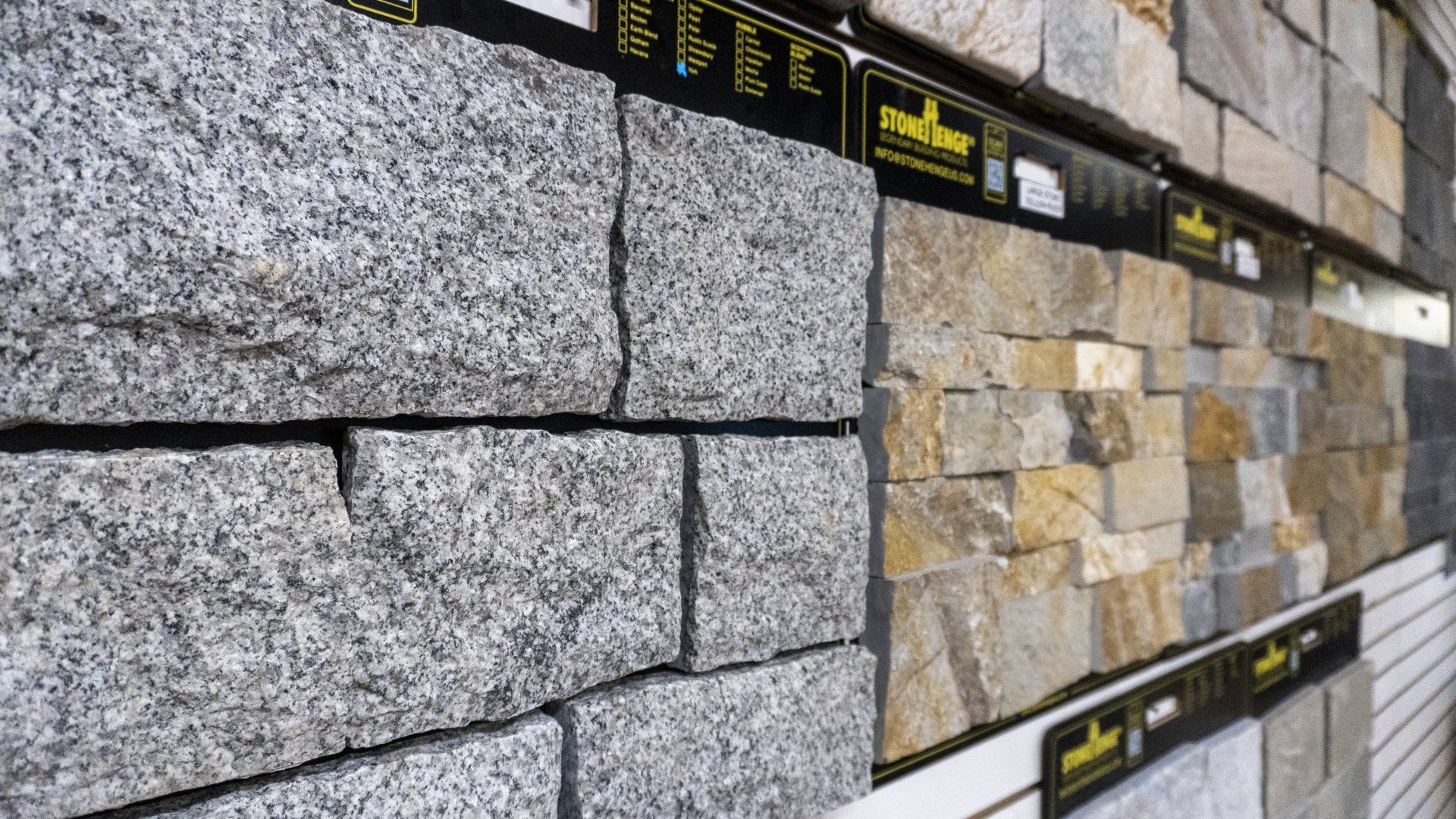 A wall with a lot of different types of stone on it.