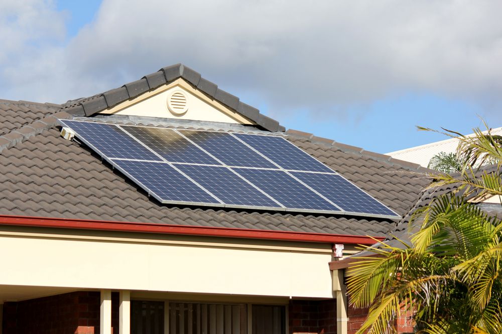 Three Workers in Safety Gear Inspect Solar Panels in a Sunny Outdoor Field — JPower Energy in Kamerunga, QLD