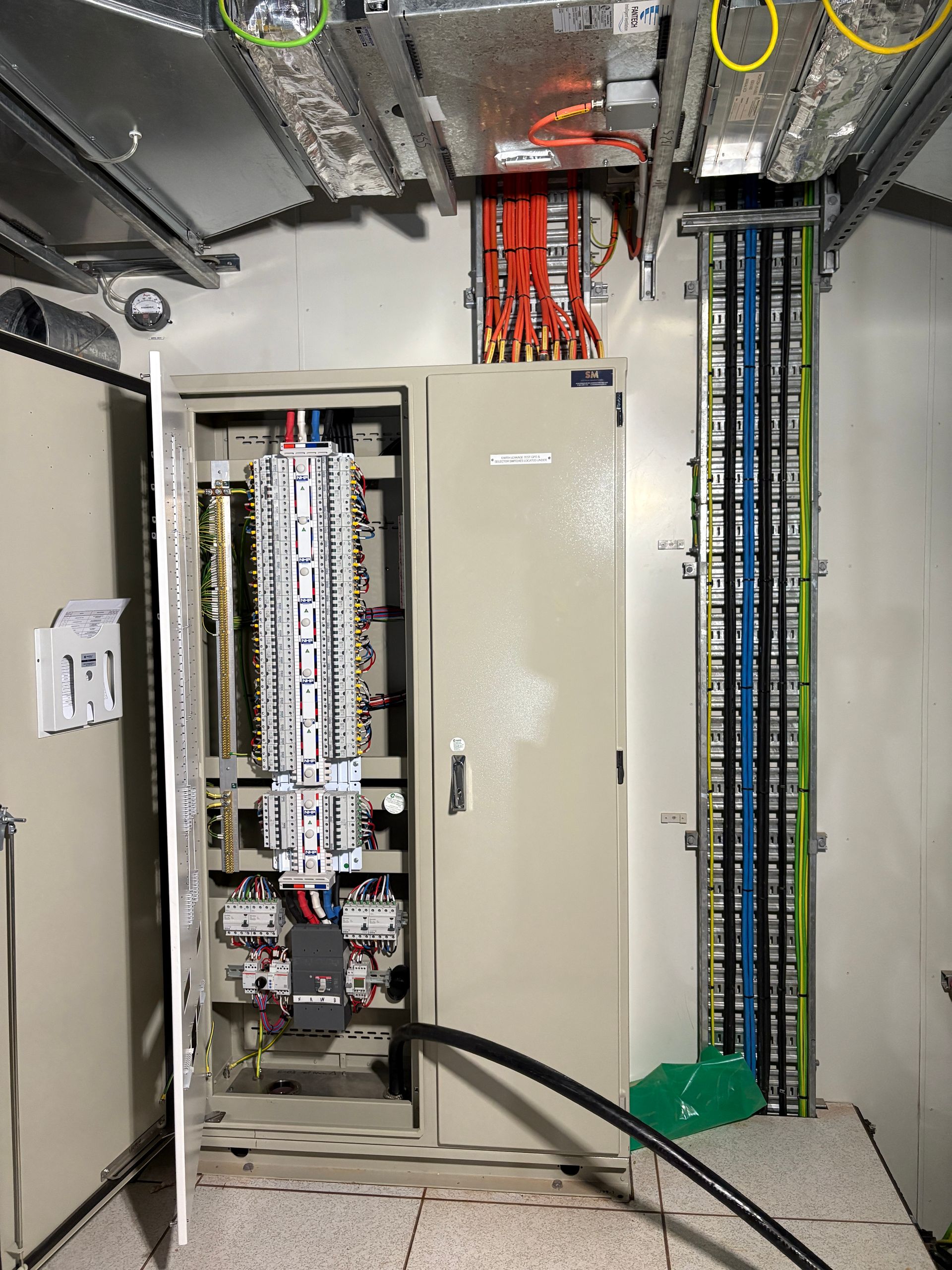 Electrical Panel With Open Door, Colorful Wires, Conduit, And Cable Trays In An Industrial Setting — JPower Energy in Kamerunga, QLD