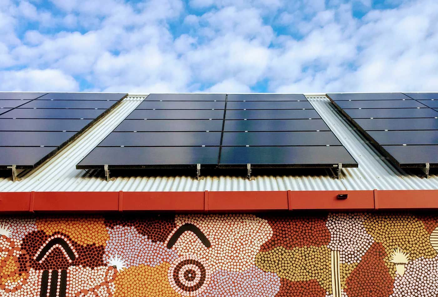 Solar Panels on a Rooftop Overlooking a City Skyline — JPower Energy in Kamerunga, QLD