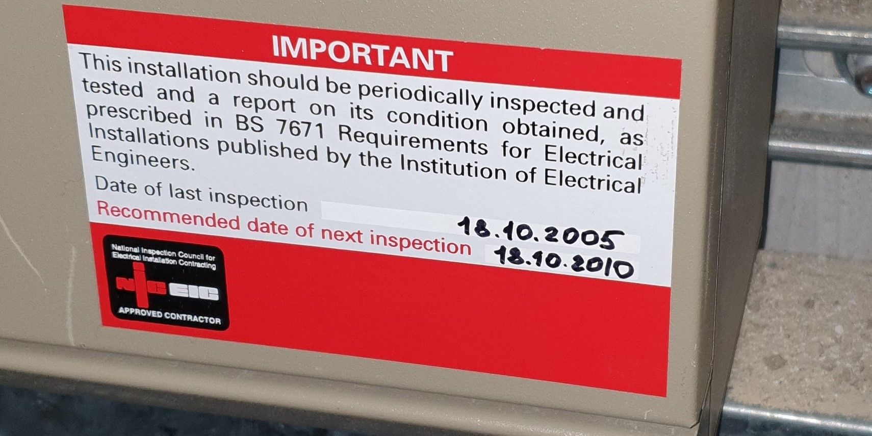 A next inspection label for electrical installations in the UK shows when the fixed wiring in your workplace should be inspected and tested as part of an EICR. Normally every 5 years for commercial buildings and offices, but it depends on the buildings use. No label.... it probably needs testing as soon as possible.