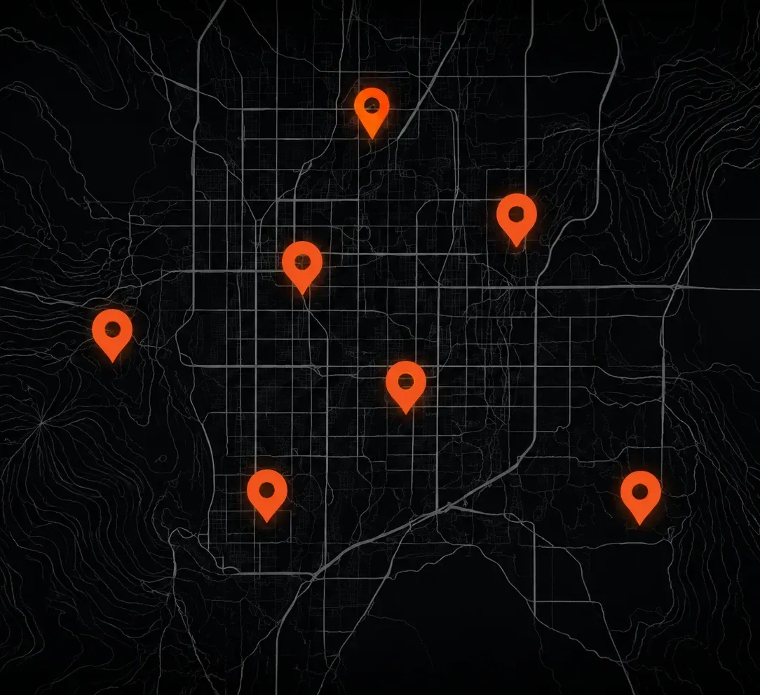 Dark city map with seven orange location pins scattered across the streets