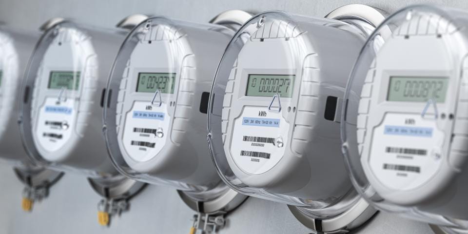 Electric Meters Close-up of a row of digital electric meters with clear protective covers, mounted on a wall.