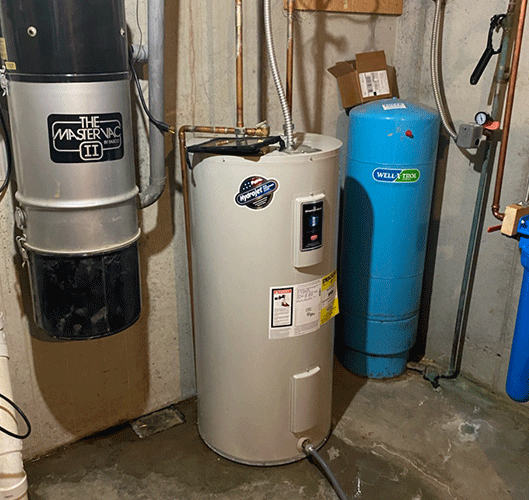 A water heater and a vacuum cleaner in a basement