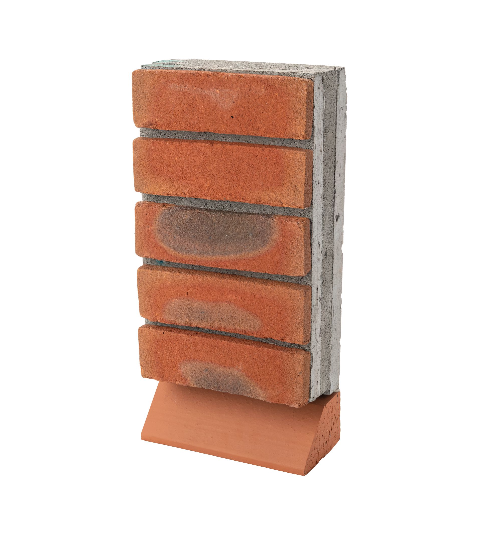 Stacked red-orange and gray brick wall panel on a small base stand
