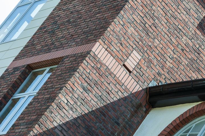 Brick building facade with angled walls and windows