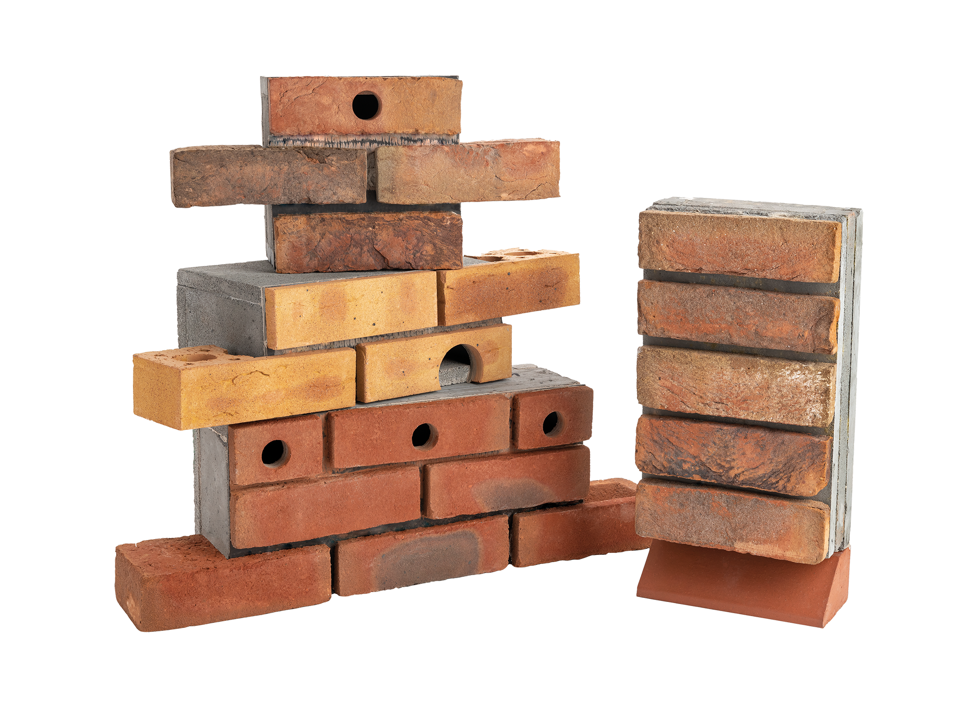 Stacked bricks and wooden blocks arranged like a small wall, with a separate stack on the right.