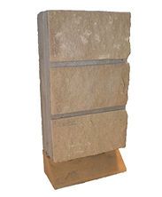Tan stone wall sample with horizontal gray bands on a small base stand