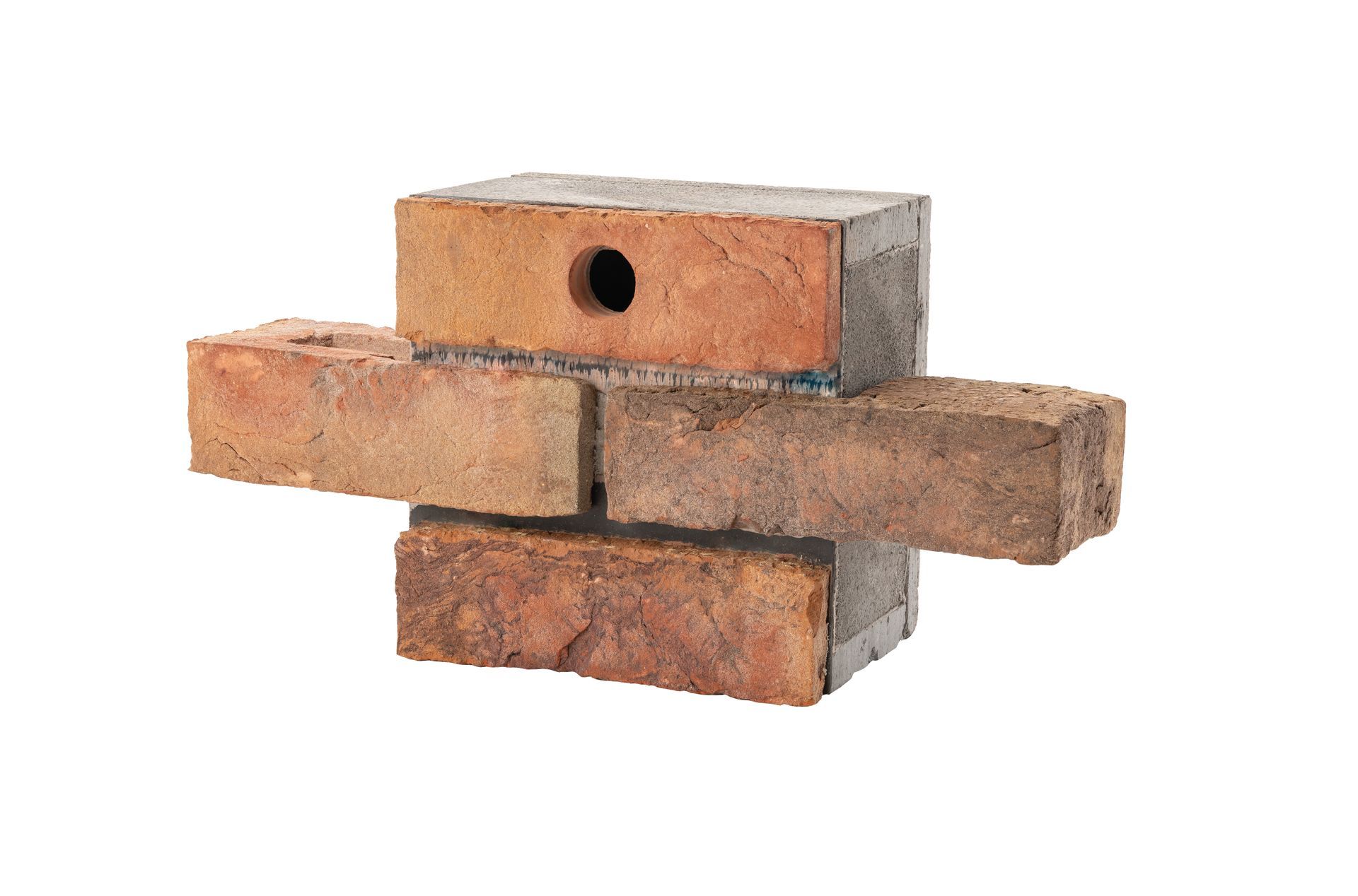 Stacked red bricks with a central hole, arranged like a small wall on a white background