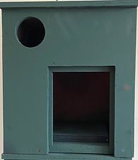 Green box-shaped enclosure with a round hole and a square opening on the front.