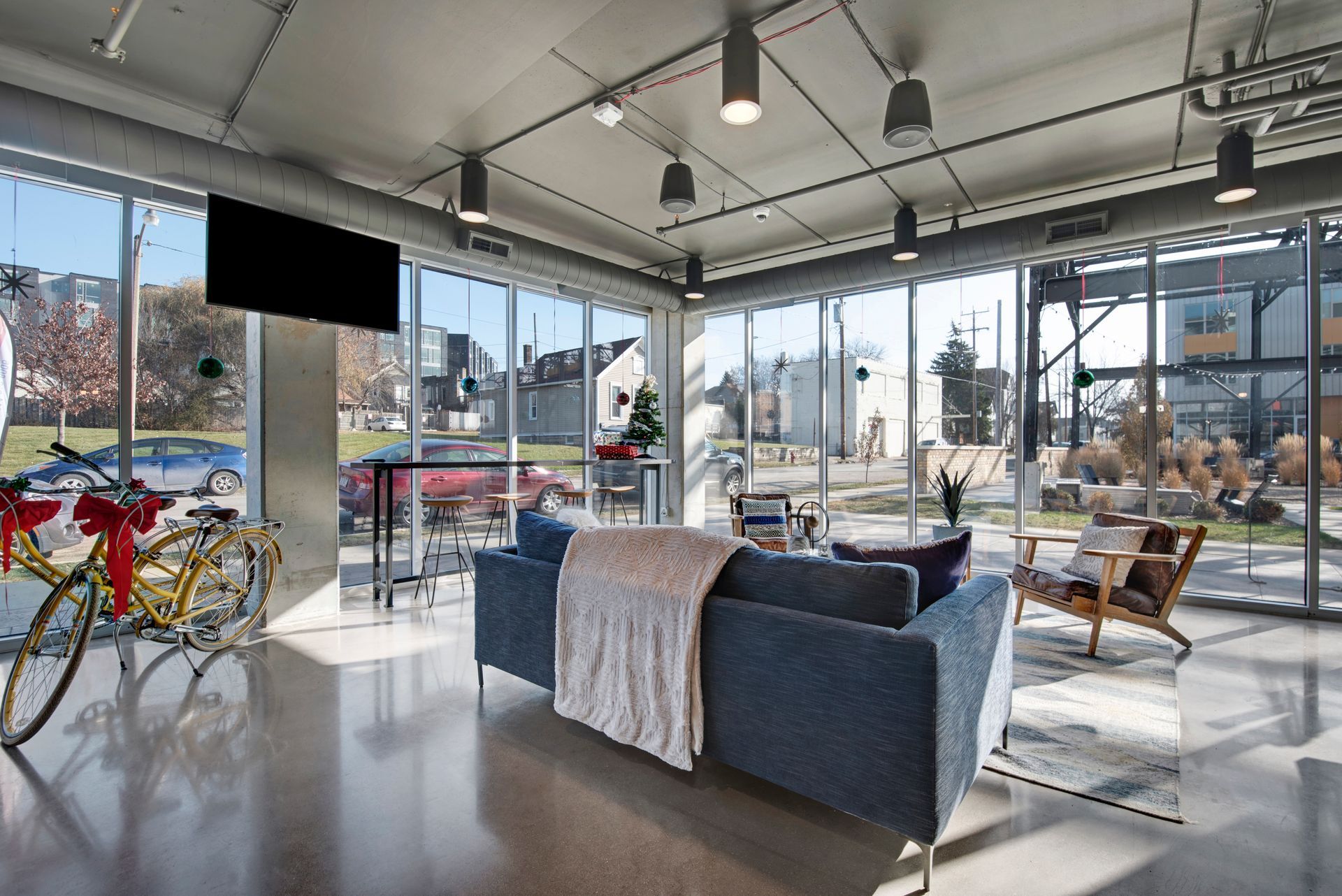 A room with a couch , chairs , and a television.
