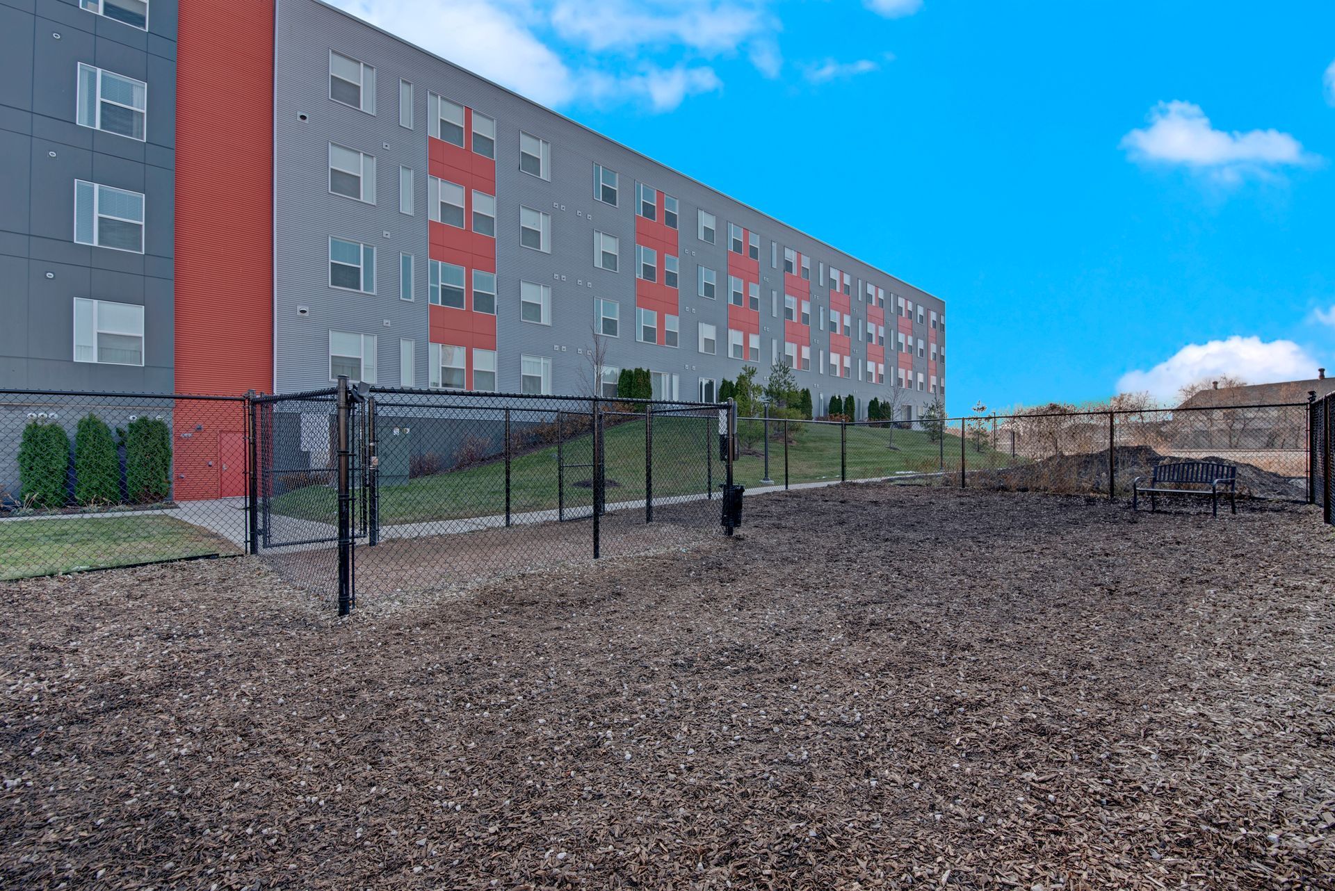 A large building with a fence around it and a playground in front of it.