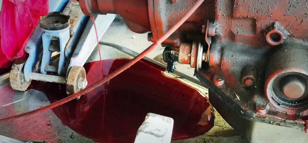 A red liquid is coming out of a hole in a machine.
