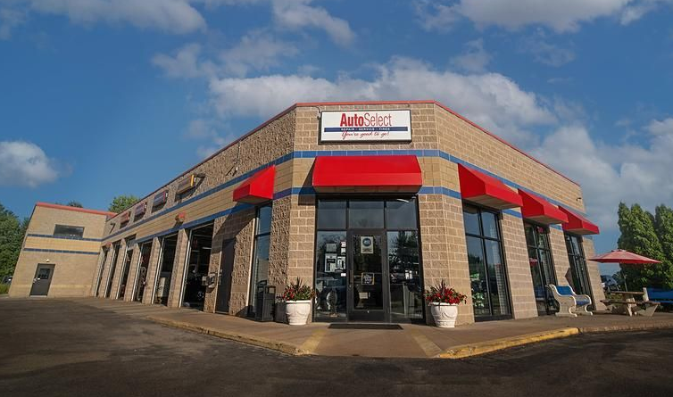 A large brick building with red awnings on the side of it.
