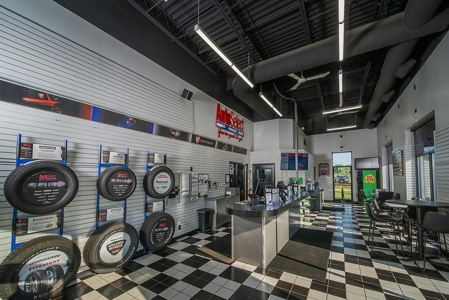 A store filled with lots of tires and a checkered floor.