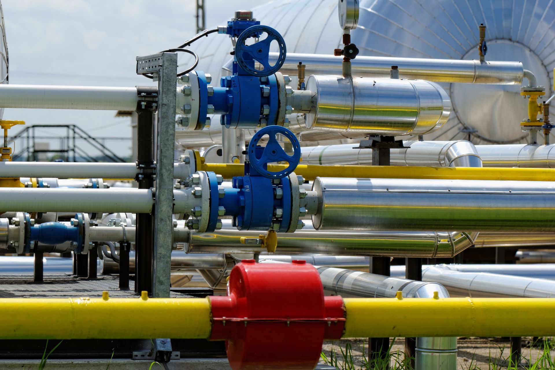 A bunch of pipes with blue valves on them