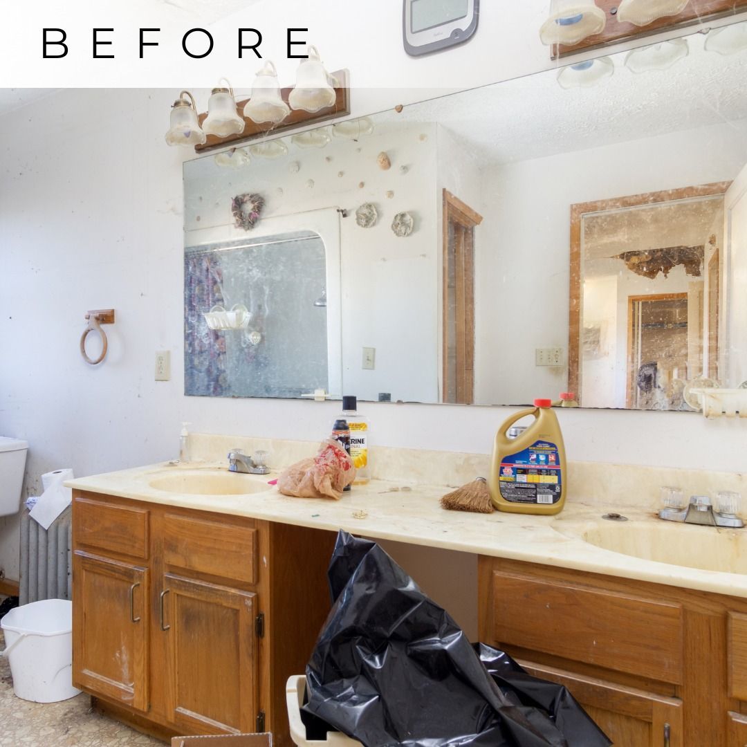 Bathroom vanity with cluttered sink and countertop, wooden cabinets, large mirror, and “BEFORE” text at top.