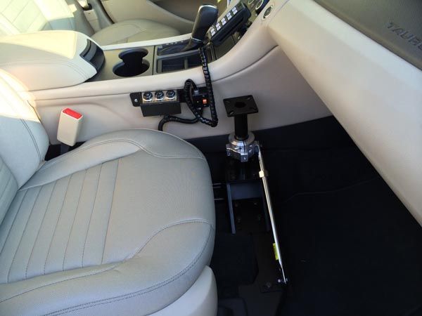 Interior car view showing adaptive driving controls installed near the driver's seat.