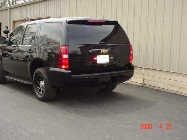 Black Chevrolet Tahoe SUV, parked in front of a beige building, dated April 2008.