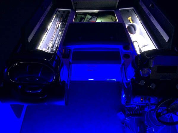Blue-lit custom arcade game with car-shaped sides and interior lighting.